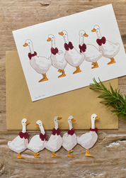 Weihnachtspapierausschnitte Gänse in einer Reihe